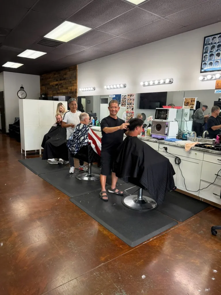 Barbers at work inside Matthews Barbershop & Salon, Weddington Road